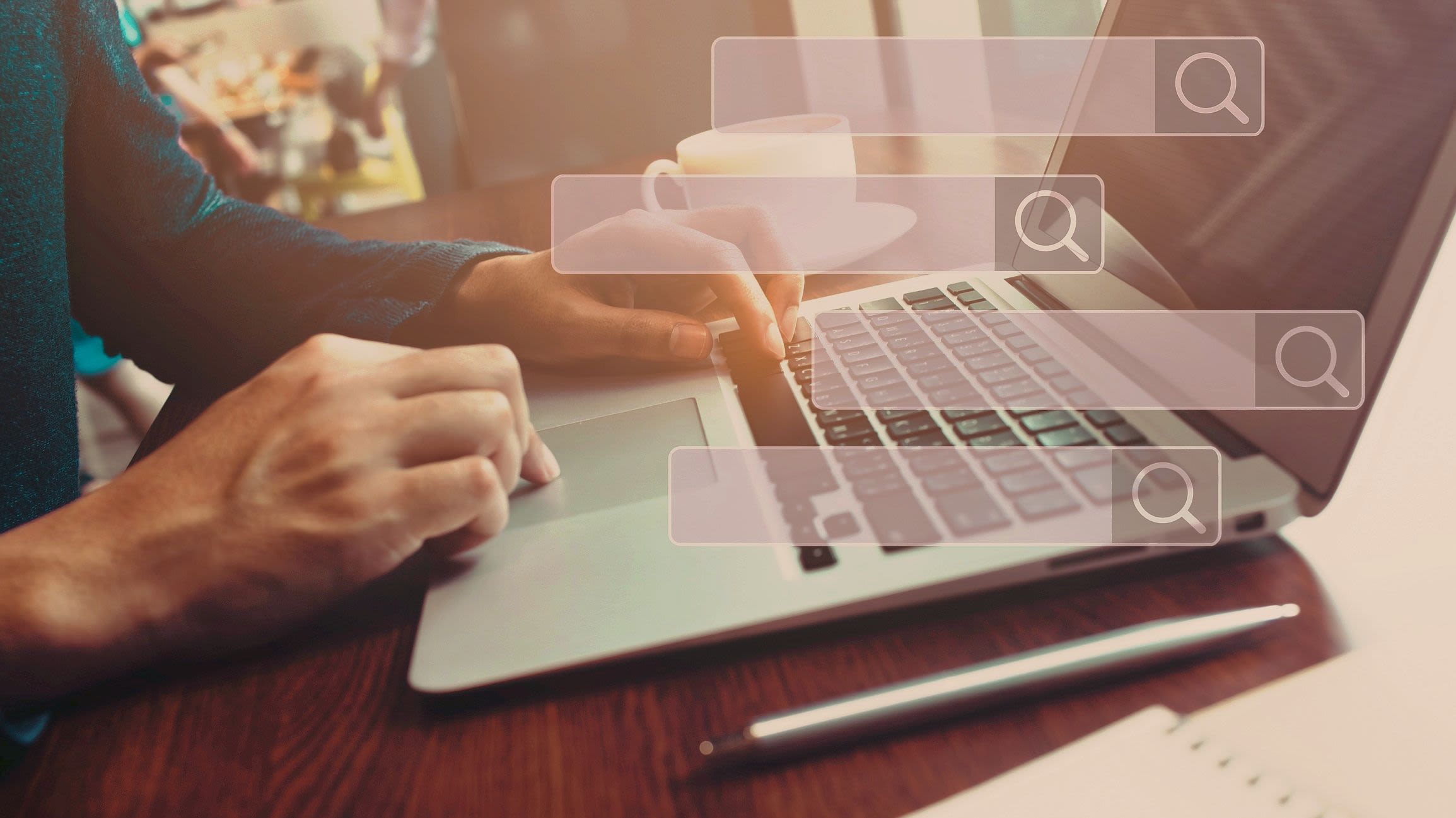 Searching and big data concepts with male hand using computer laptop in cafe bar with search engine icon sign.Business information.global network system