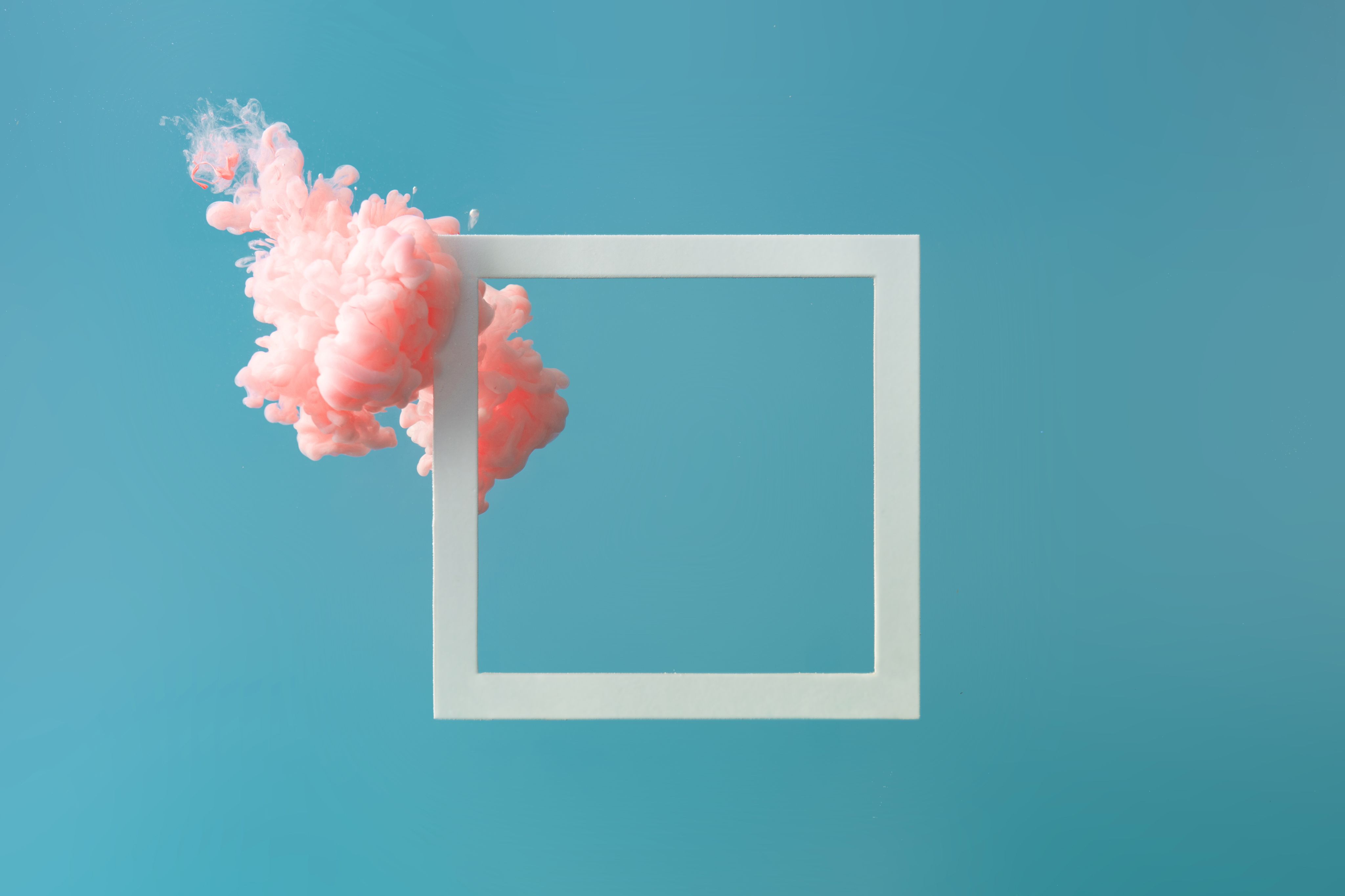 Stylised image of a pink cloud against a blue background with an empty picture frame