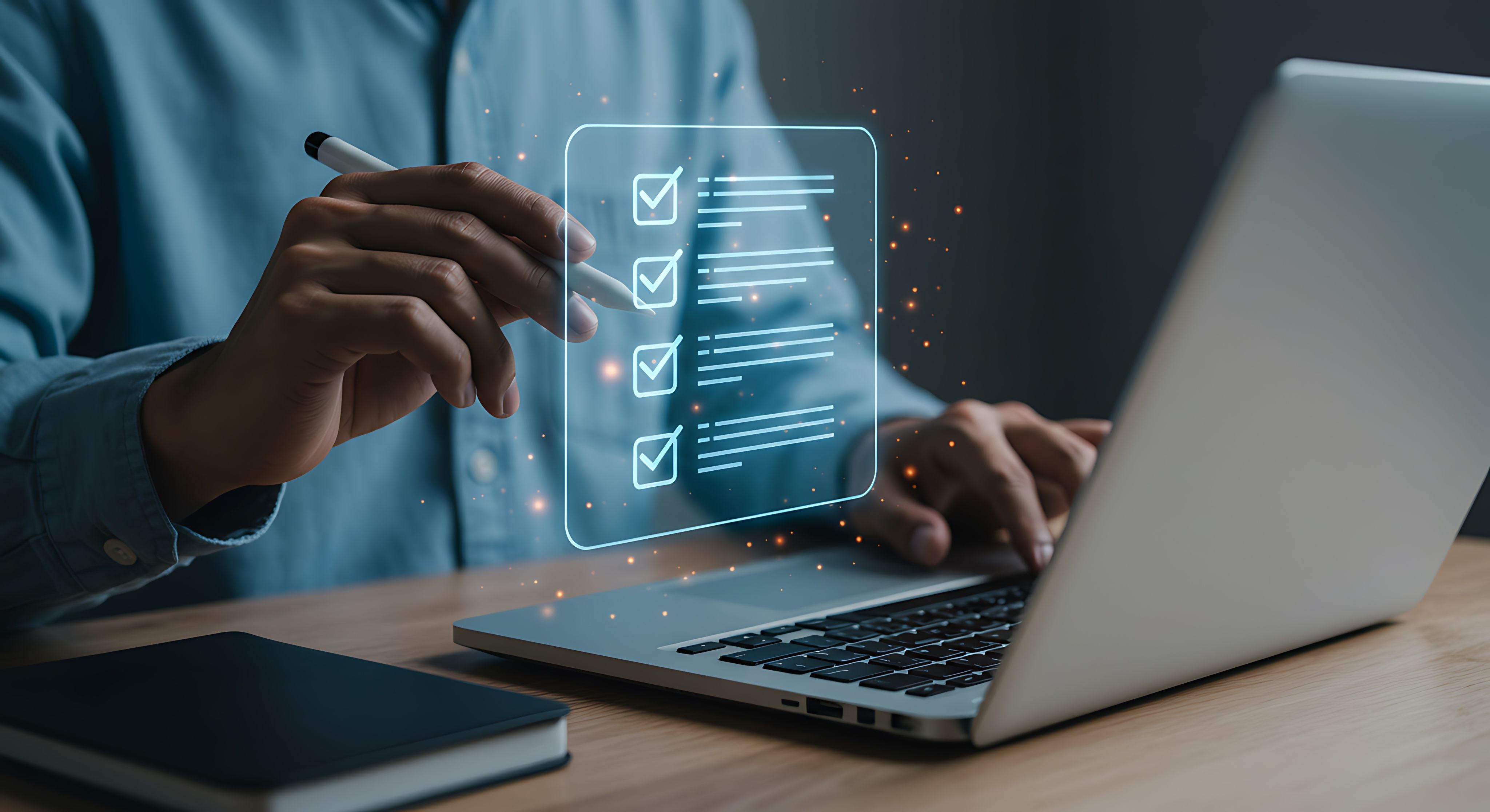 Person ticking off items on a tick list in front of a laptop