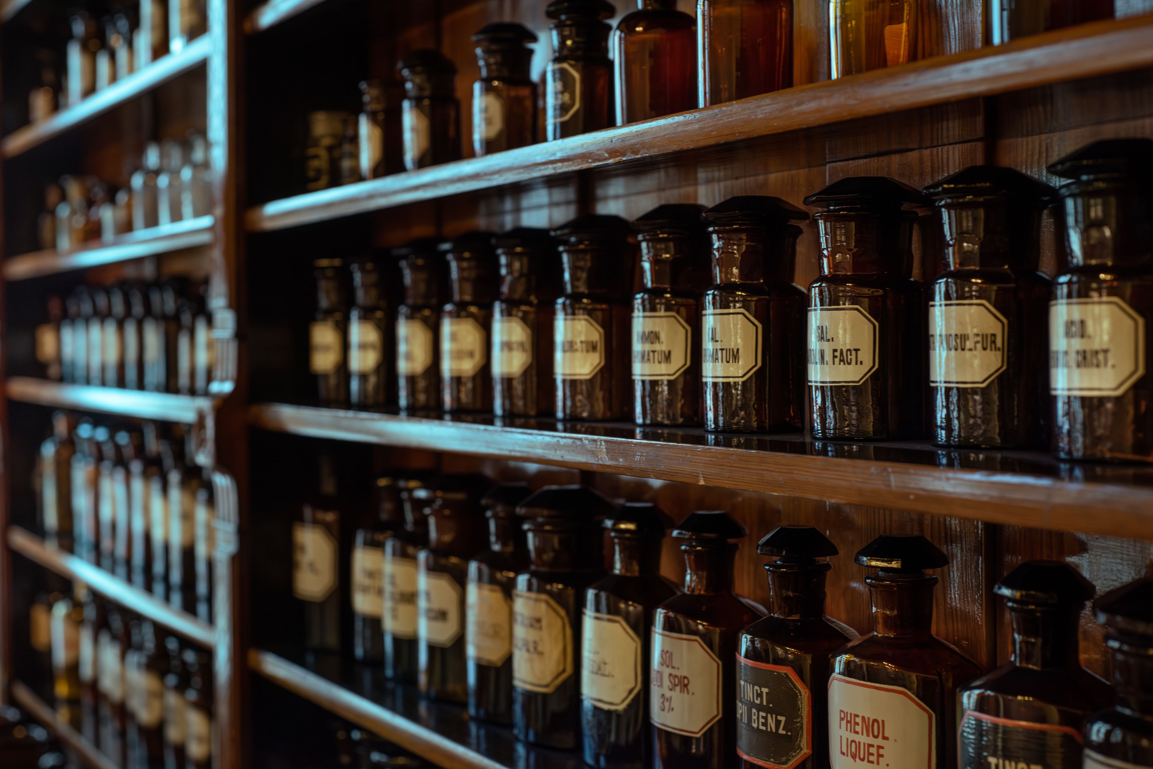 Bottles with drugs from old medical, chemical and pharmaceutical glass. Chemistry and pharmacy history concept background. Medicine, chemistry, pharmacy, apothecary, alchemy history background.