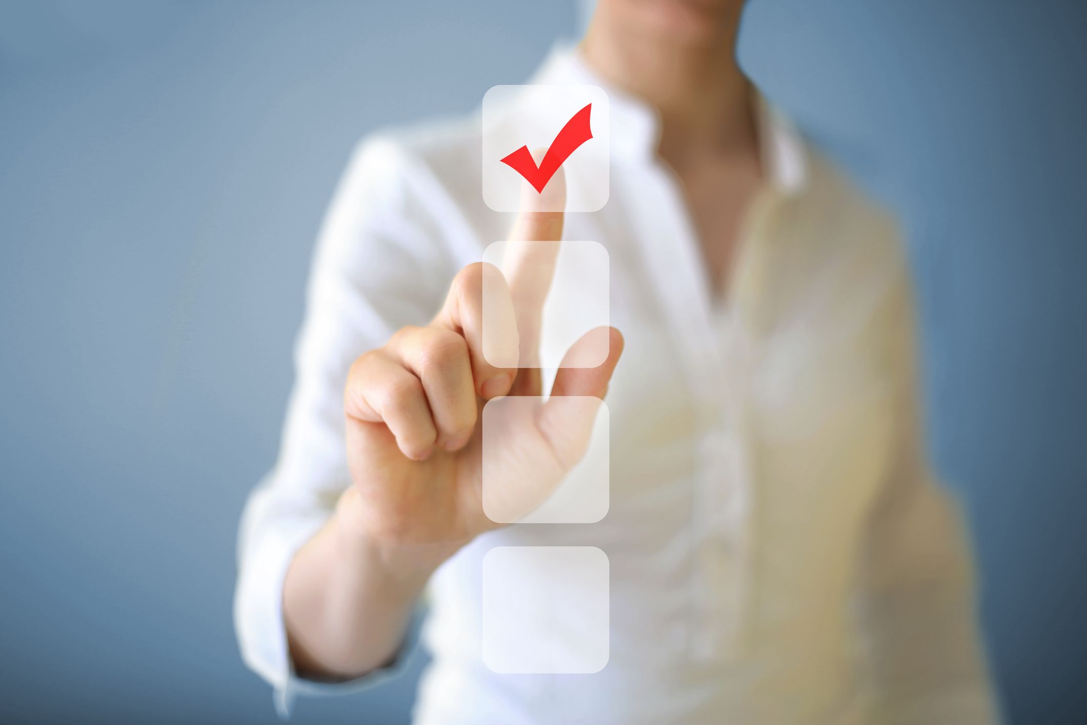 Person sitting in front of a transparent monitor, ticking items of a tick list